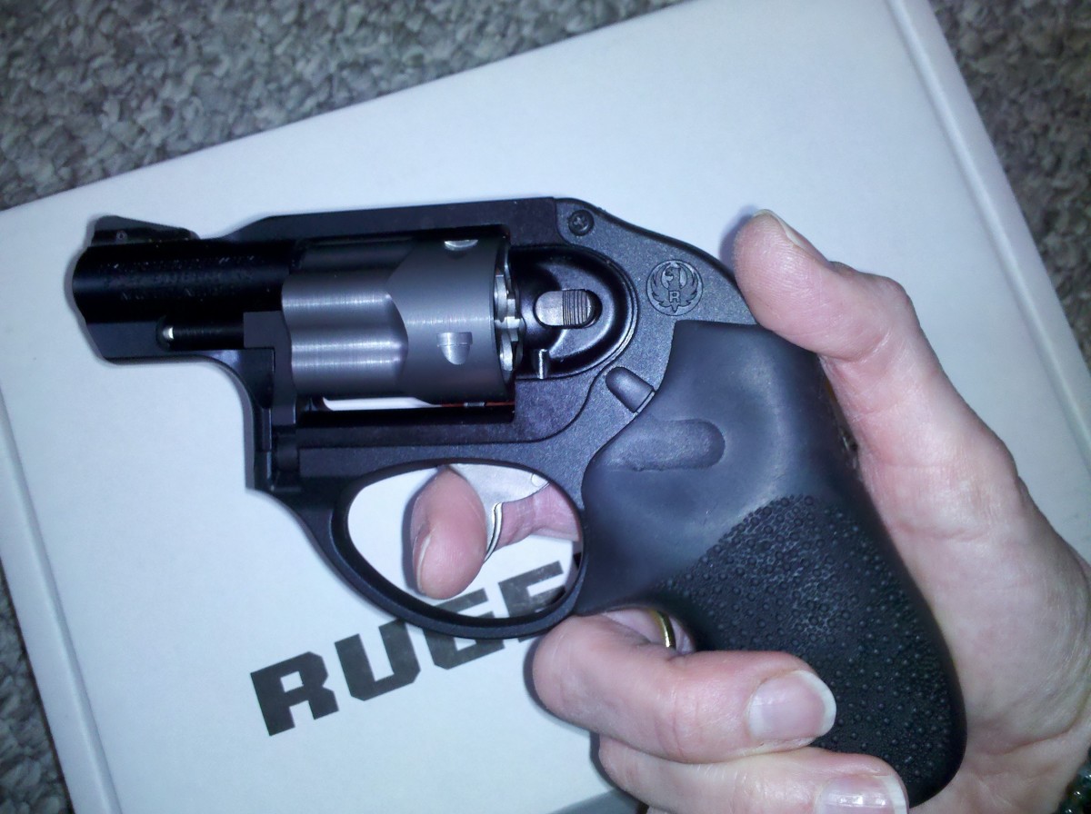 Ruger LCR revolver, .38 special, "snub-nose." It kicks but it is the purse gun of the 21st century.