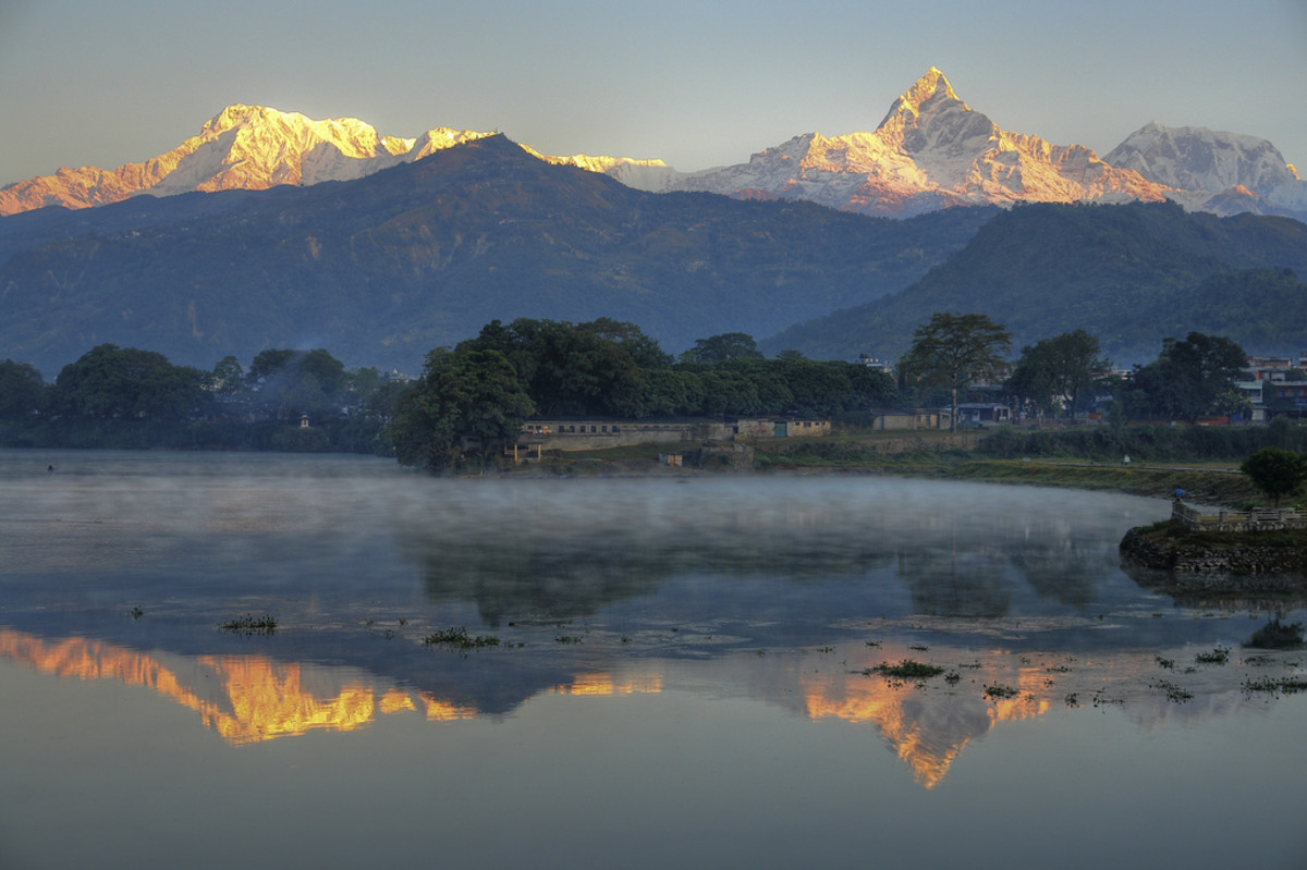 A view of Annapurna (left) and Machapuchare (right) and their reflection in  Phewa Lake from Pokhara.