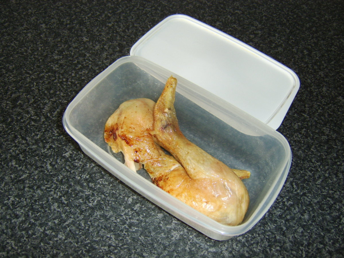Chicken legs and thighs in plastic dish ready to be taken fishing.