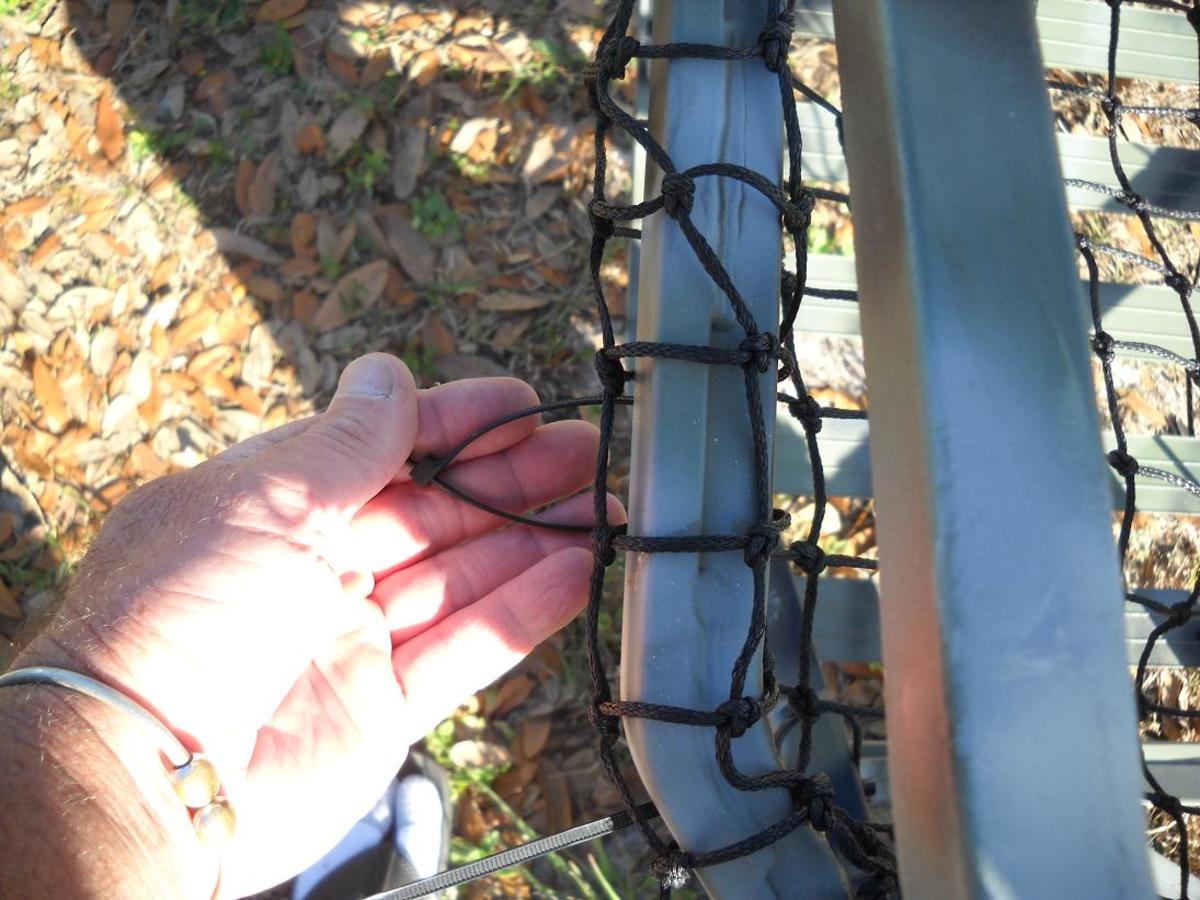 Tie the first side with a simple loop around the rail, tying the netting to itself.