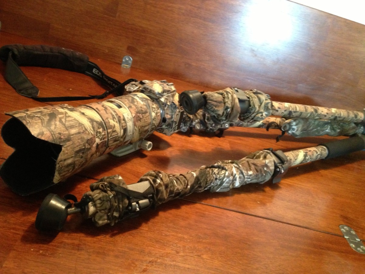 This photo shows camo tape on most of the surfaces and the telescoping fabric sleeve on the tripod legs. 