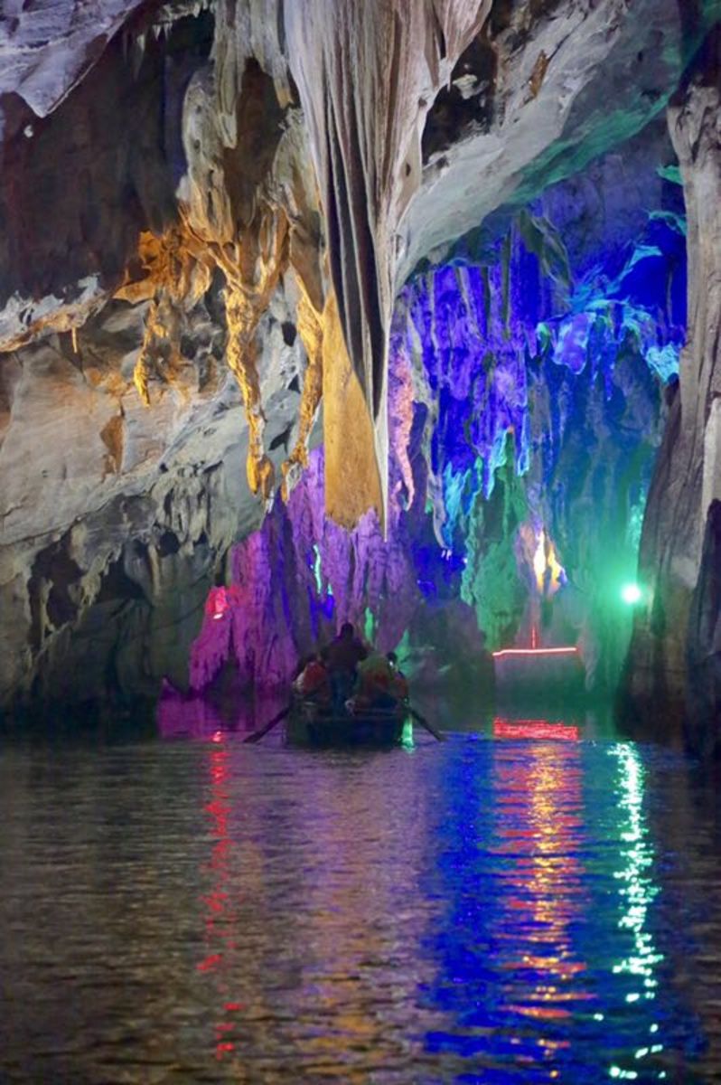 Colorful lighting in the fascinating caves accessed by tour boat. 