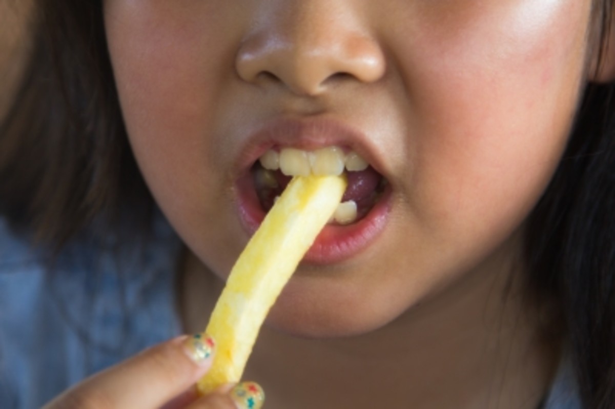 Asian Girl Eating French Fries. By tiverylucky Stock Photo ID 100220837  29 November 2013