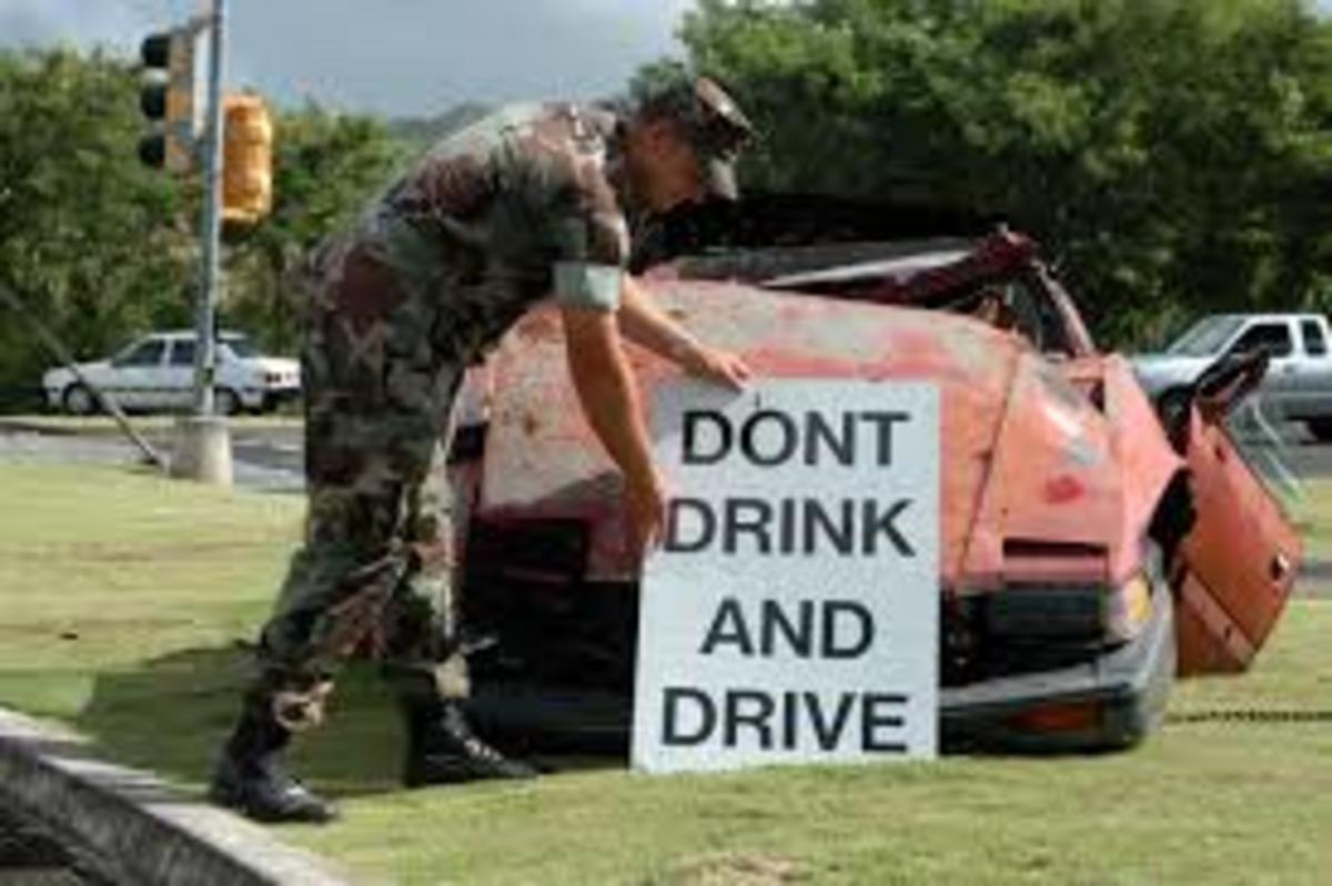 A soldier puts up a warning against drunk driving.