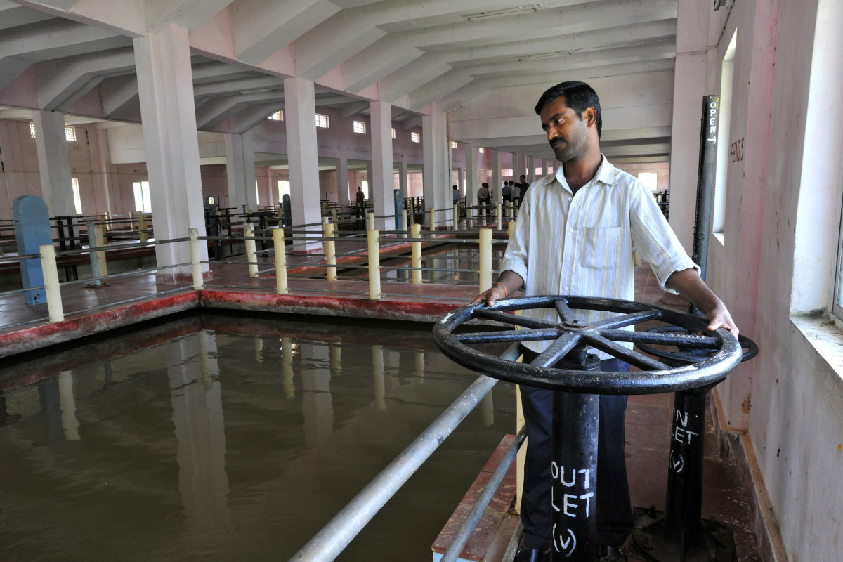 An employee working at a water treatment plant.