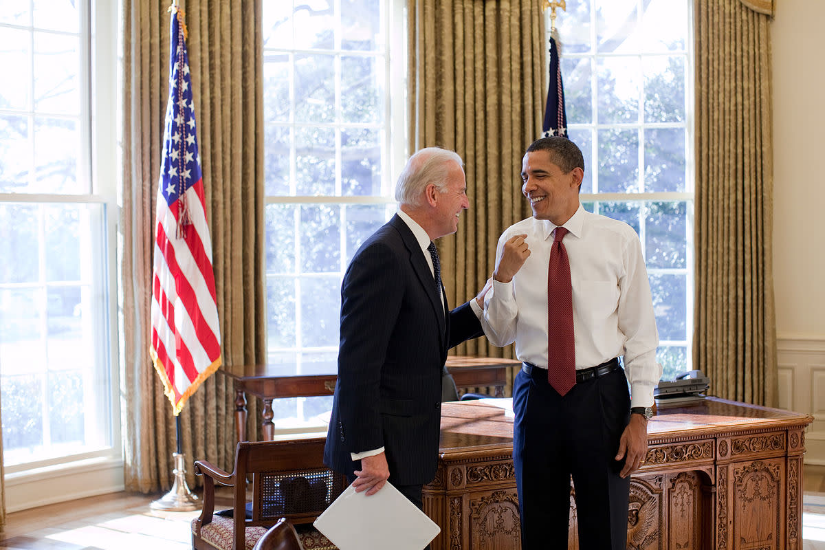 President Barack Obama and Vice President Joe Biden laugh together in the Oval Office, January 22, 2009.