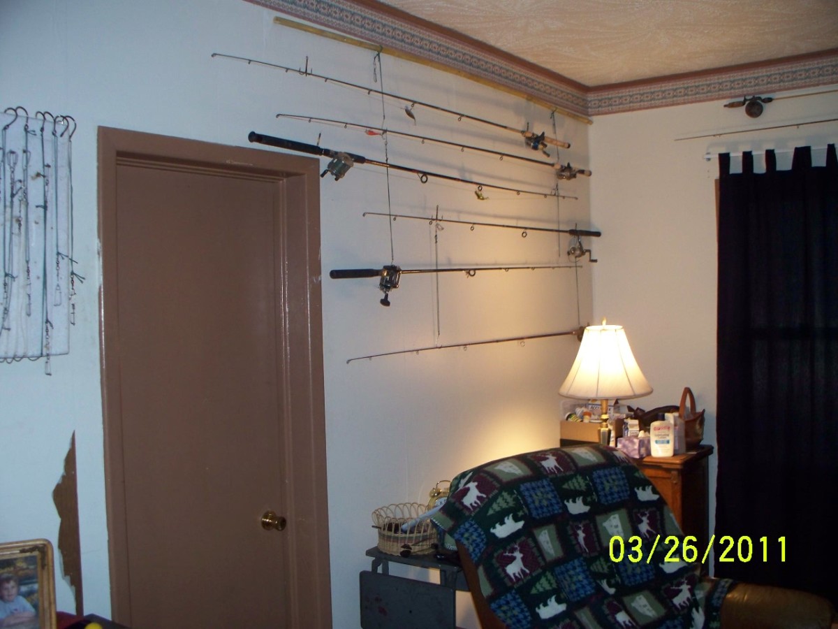 Old fishing poles can be used as a form of wall art. Simply hang them from a bamboo pole and fishing line.