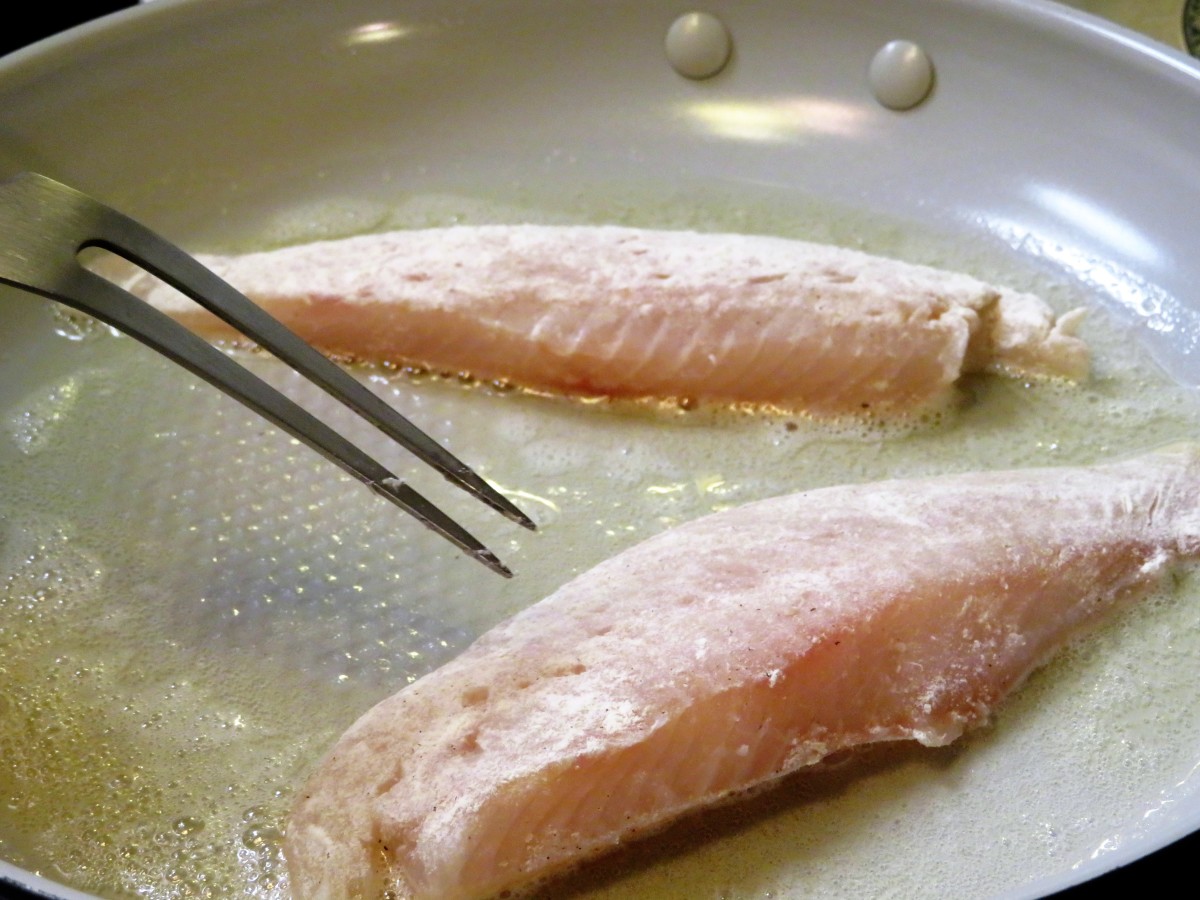 The larger half of the fish fillets are in the pan for a few minutes before the thinner parts are added.