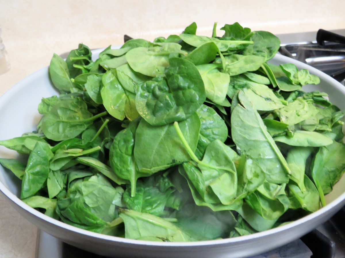 Add the fresh spinach leaves to the pan with the onions.