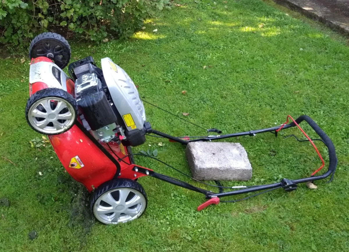 Alternatively lower the mower back onto its handles. A weight such as a block will keep it in place.