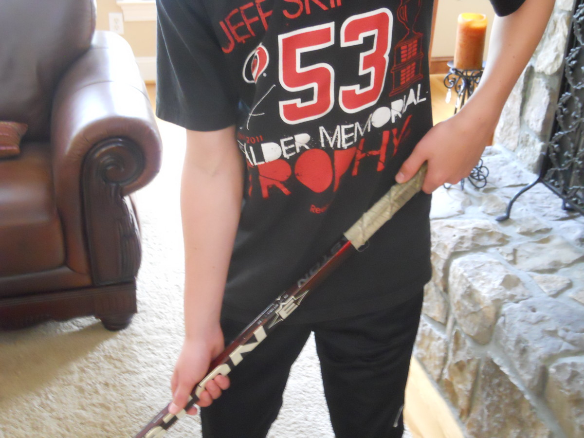 The player's dominant hand goes on top of the hockey stick.