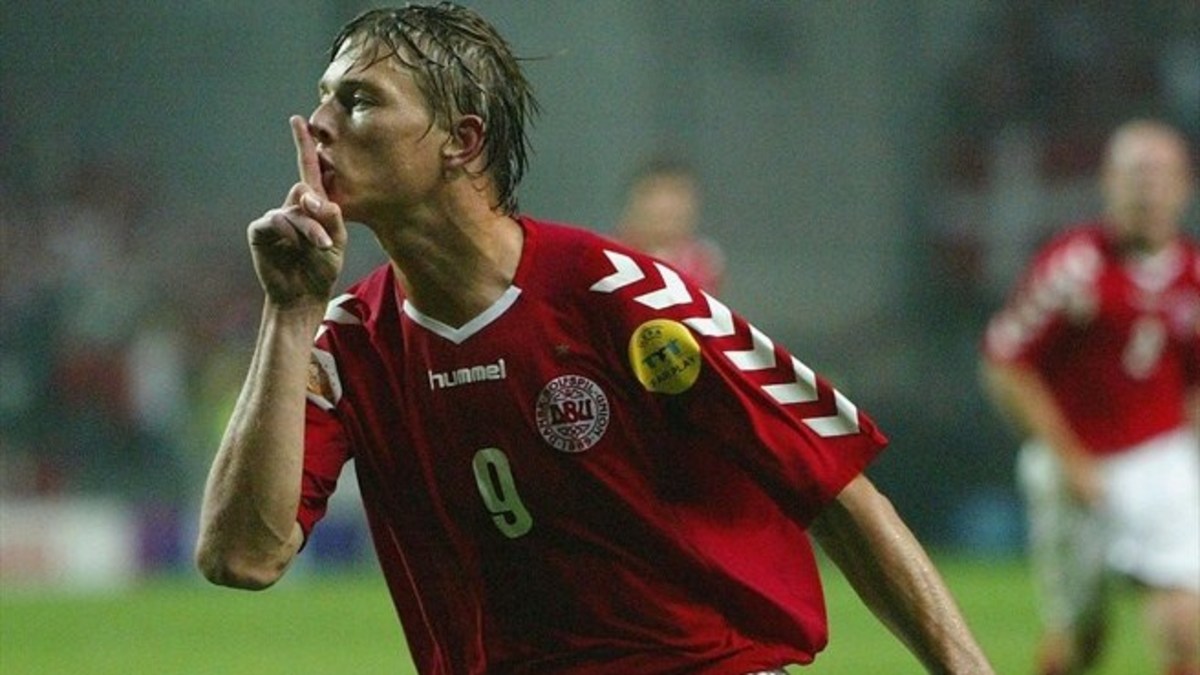 Denmark's Jon Dahl Tomasson silences the crowd after scoring the first goal of the game in a Euro 2004 Group C match.