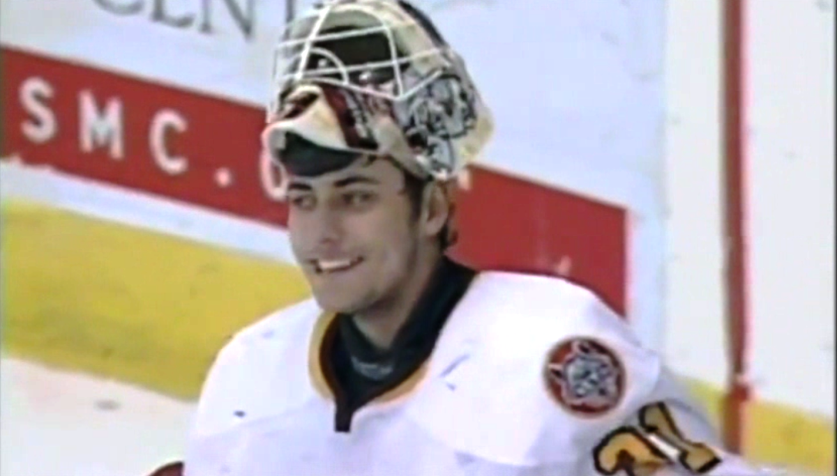 The goalie is the guy with the mask. Sometimes he's cute, too. Photo of Ondrej Pavelec, from video.
