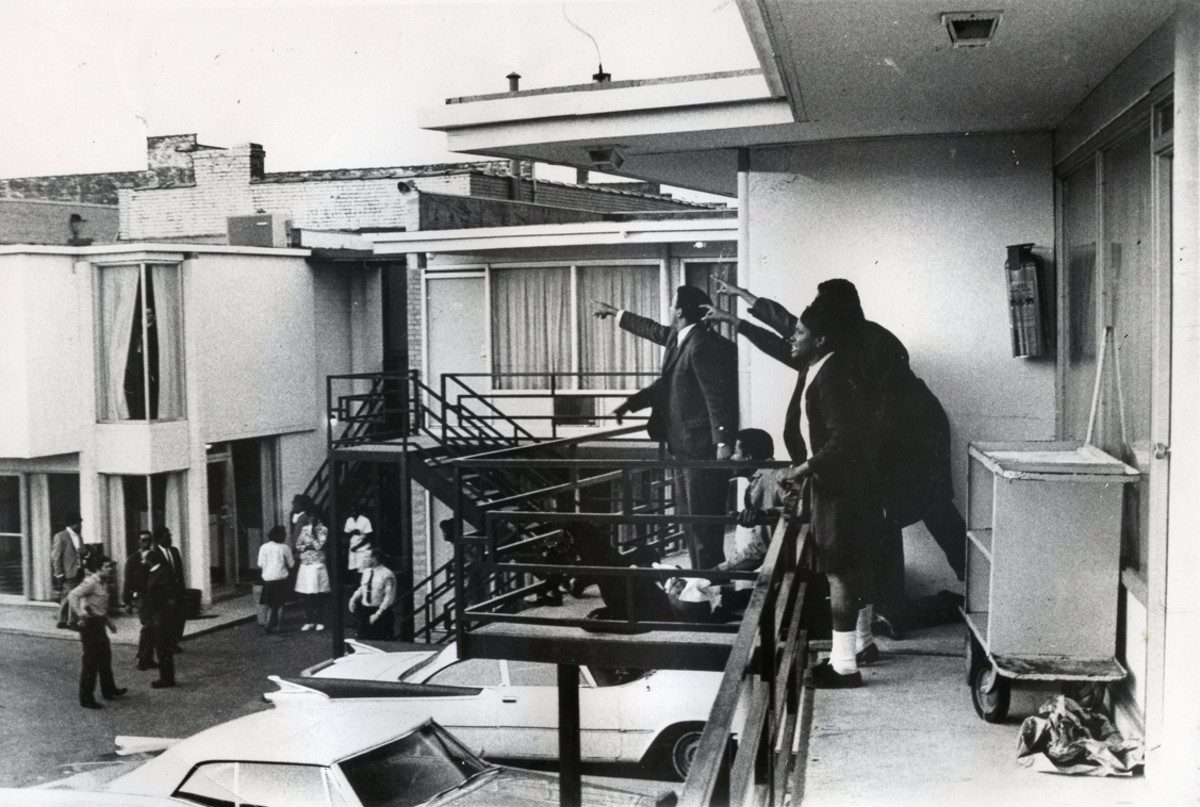 Dr. King lies mortally wounded as his aides point to where the shots rang out. 