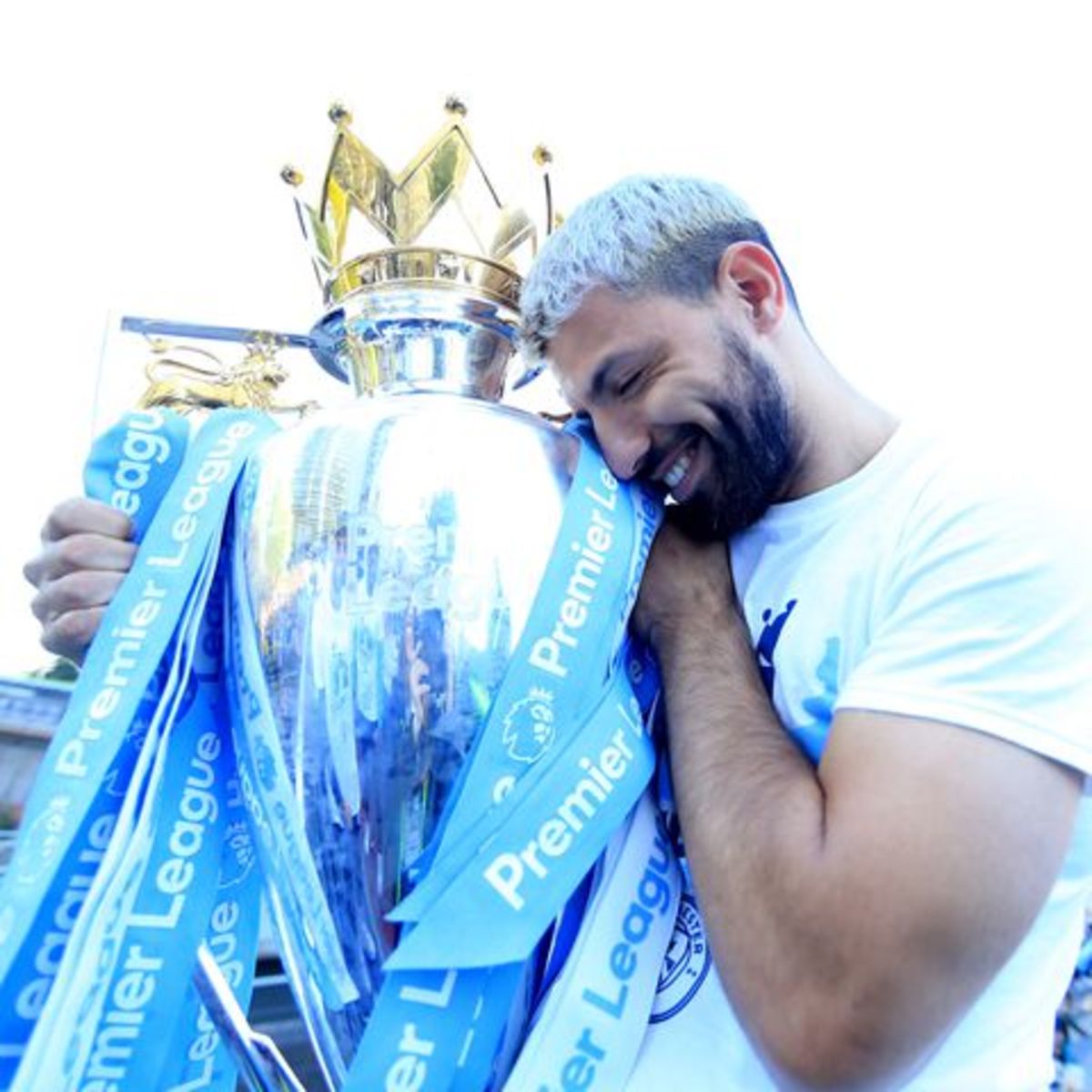 Aguero hugging the Premier League trophy.