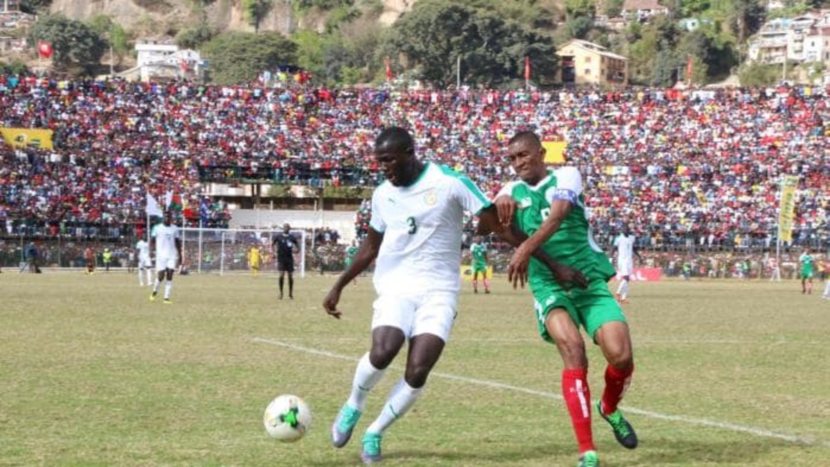 Senegals' Kalidou Koulibaly (#3) and Madagascar's Ima Fanev Andriatsima battle for possession during a 2019 Africa Cup of Nations match. The 2-2 draw was marred by a stampede that killed one person and left 37 people injured.