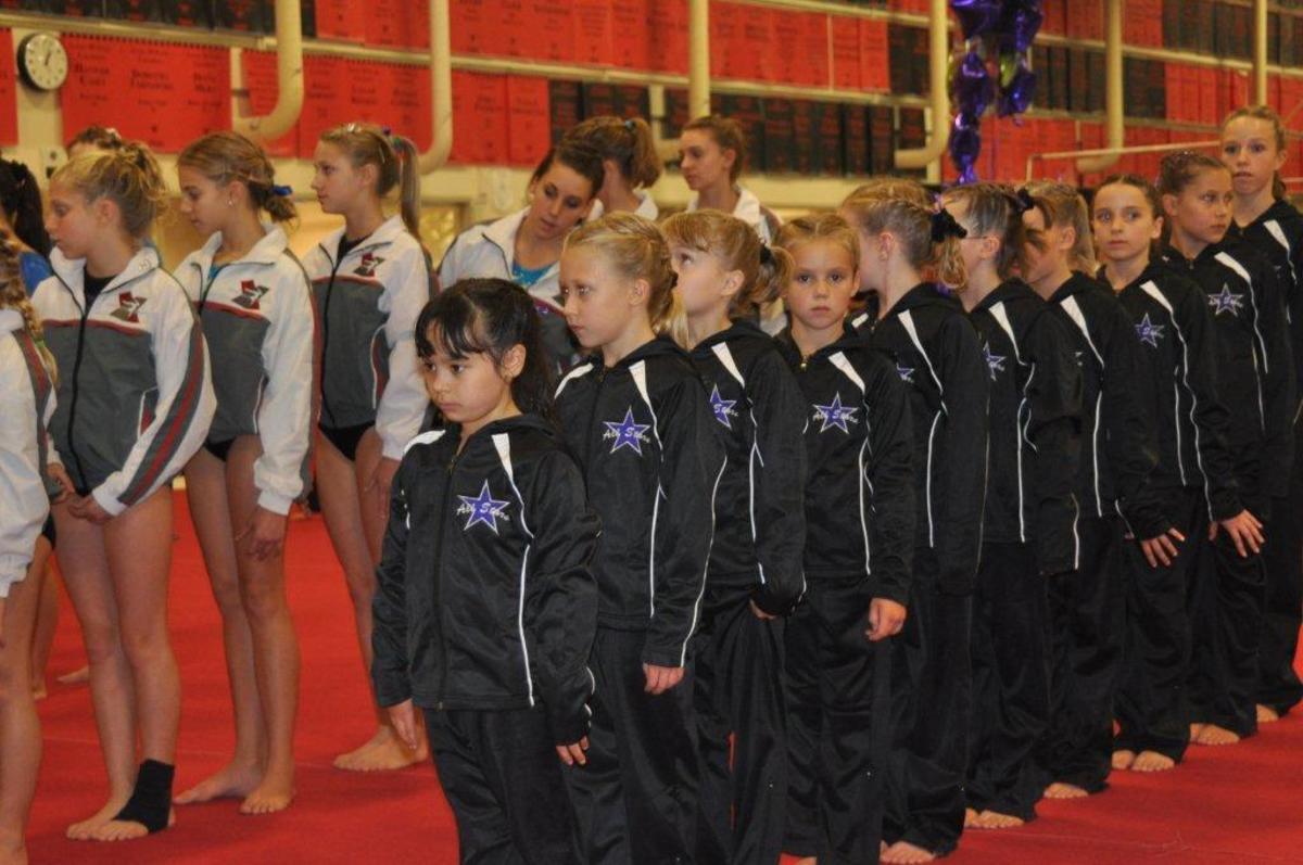 Teams march in prior to the start of a Level 5 gymnastics meet