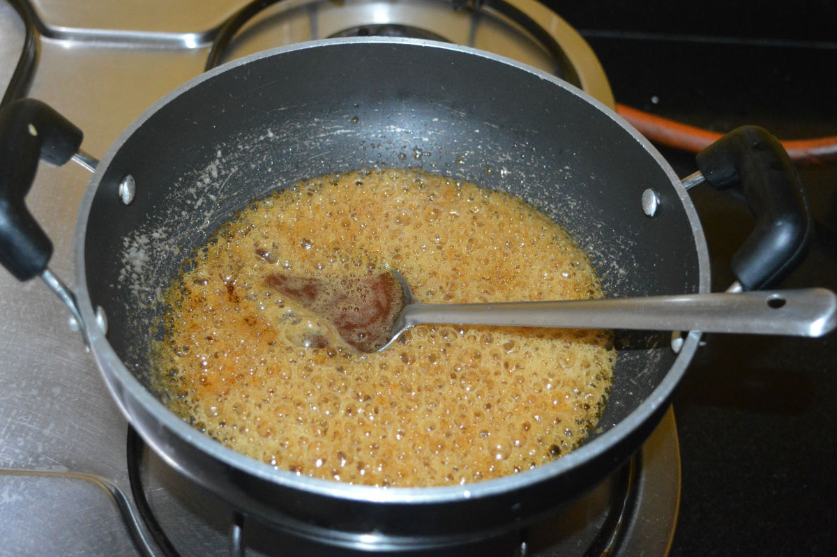 Allow it to boil on low heat until the jaggery syrup becomes thick and gets two-string consistency. 