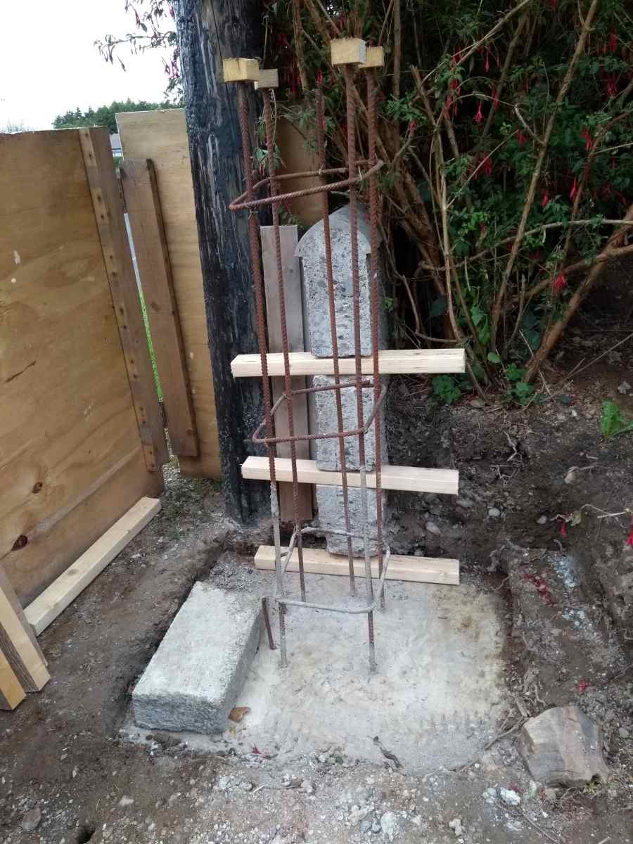 Parts of the timber rings in position. Note the pieces of wood pushed down onto the top ends of the of the rebar. It's easy to get an eye injury from bars or garden canes sticking up from the ground.