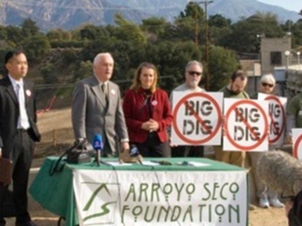 Tim Brick holds a press conference on top of Devil's Gate Dam. With him are Attorney Mitchell Tsai, Pasadena Audubon Executive Director Laura Solomon, and several protesters of the Big Dig.
