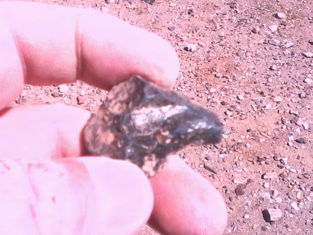 This is a piece of pyrite ore. I found this in a flat desert area near no waterway or rock formations. When I crushed it there was gold inside. Gold is where you find it!