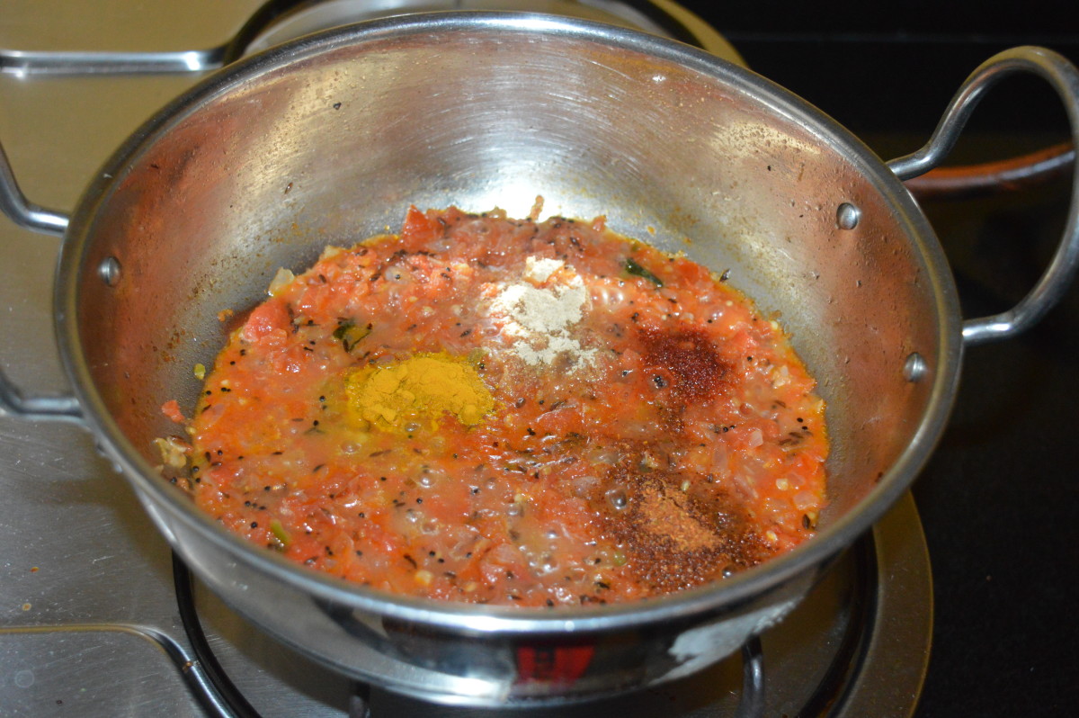 Step four: Add turmeric powder, garam masala powder, amchur powder, and red chili powder. Mix well and cook for 1 minute.