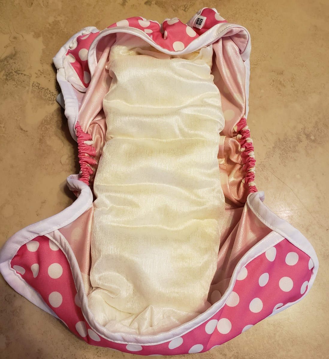 Fully Assembled Diaper and Cover: the diaper, liner and booster flip over and snap right into the cover.  Once soiled, just unsnap the diaper, remove the liner and throw it and solids away. The covers come in lots of adorable patterns (above)