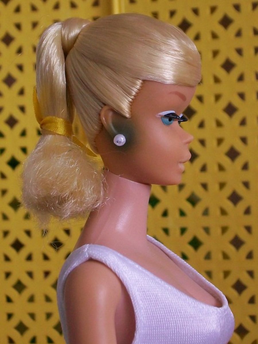 This is "green ear," which is caused by the metal from Barbie's earrings.