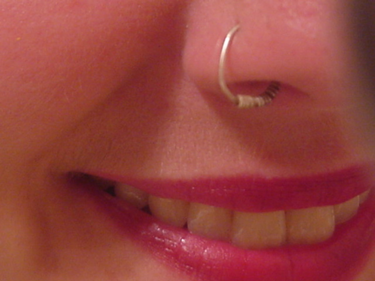 Up close picture of a woman with a nose hoop/ring.
