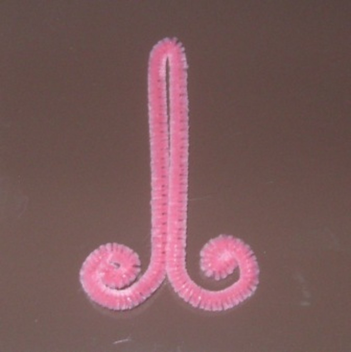 1. Bend a thin pink pipe cleaner in half and curl the ends into 2 small spirals.