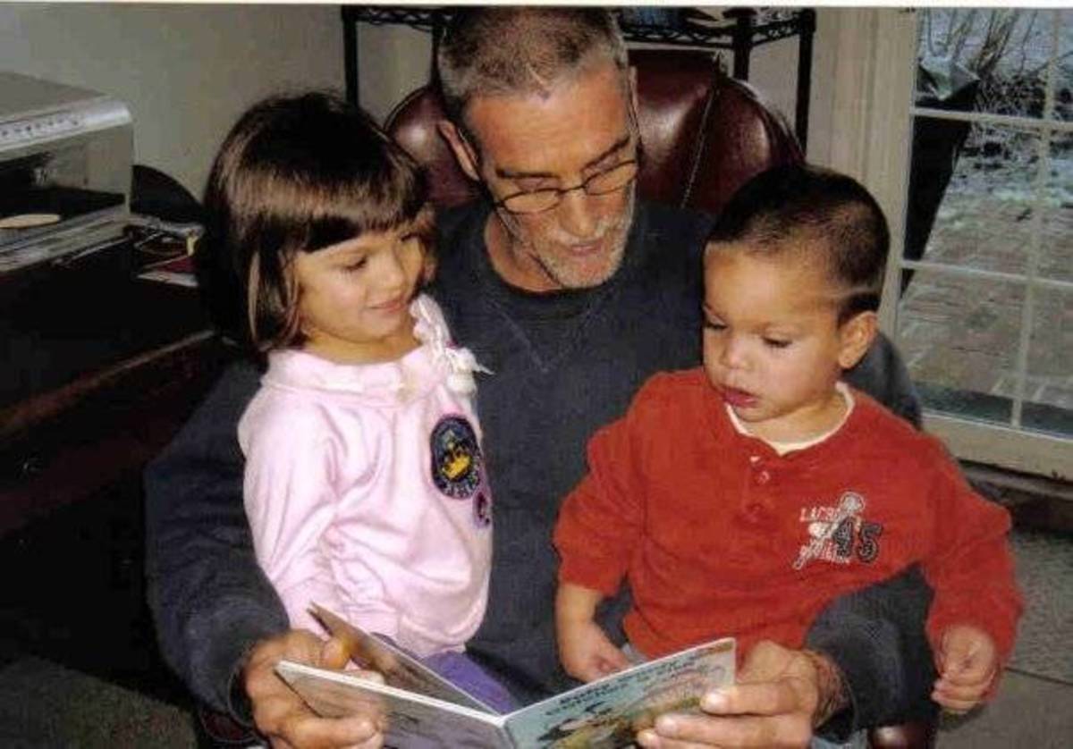 A grandfather reads to his grandchildren. Notice how engrossed they are in the story.