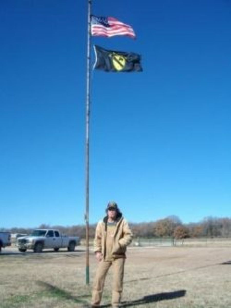 My husband in front of his flag pole, 2009