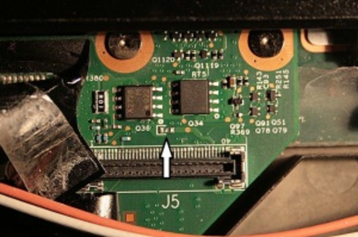 screenshot of lenovo motherboard screen connector with fuse location indicated by white arrow