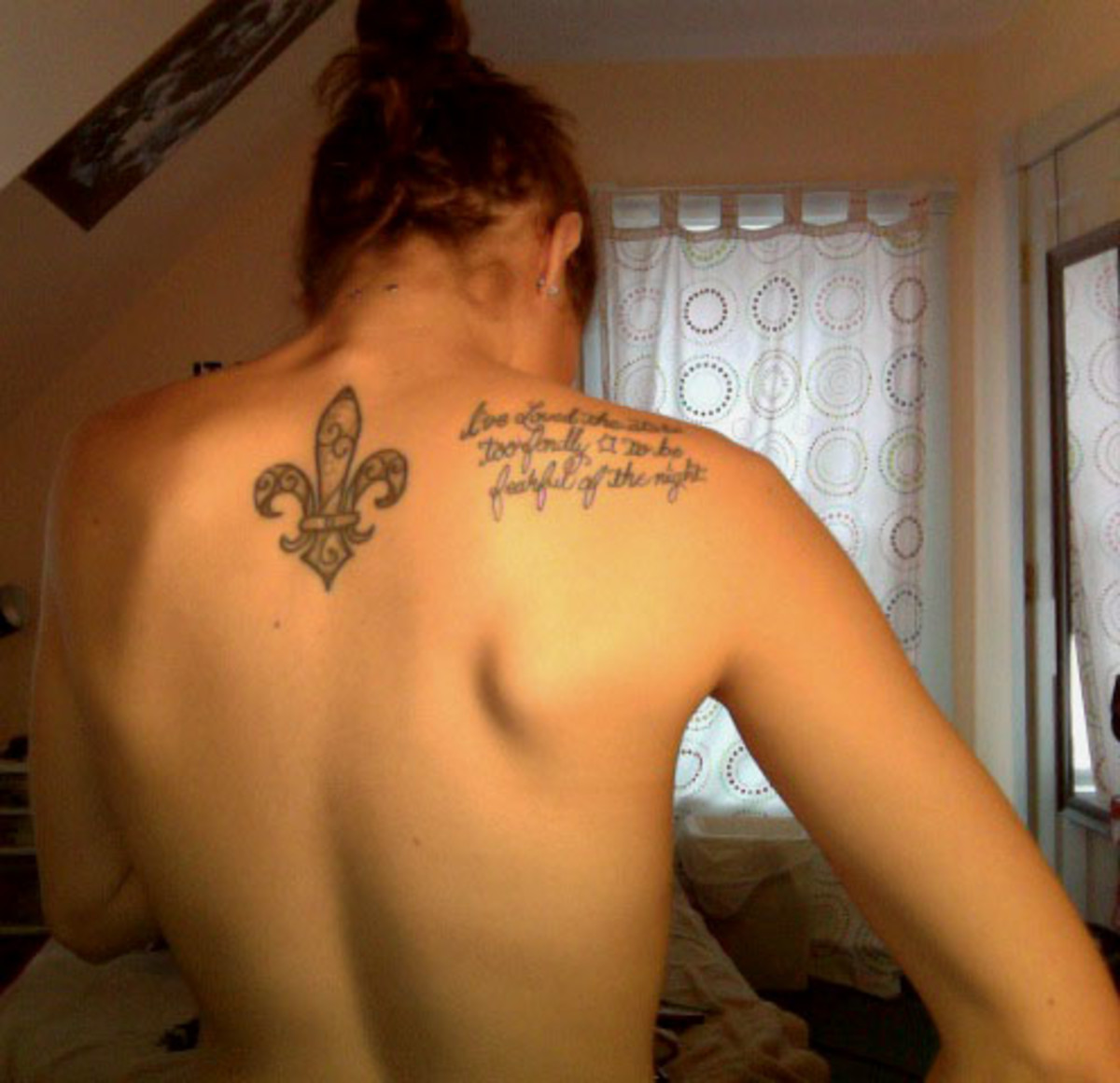 Fleur-de-lis back tattoo.