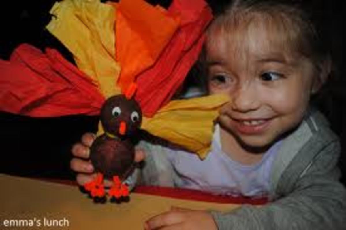 TURKEY MADE WITH 2 STYROFOAM BALLS, ORANGE PIPE-CLEANERS,  TISSUE PAPER AND GOOGLE EYES