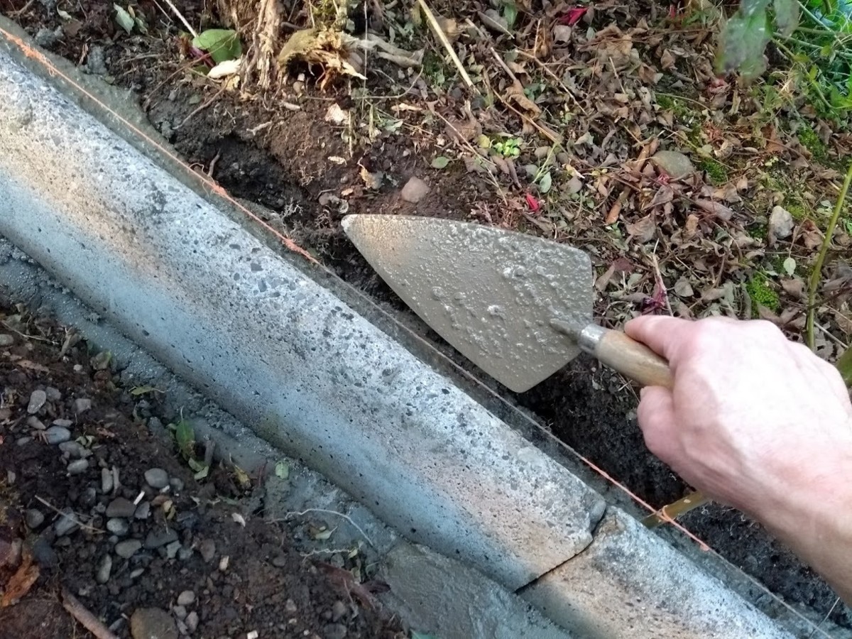 Use a trowel to place concrete at the back of edging.