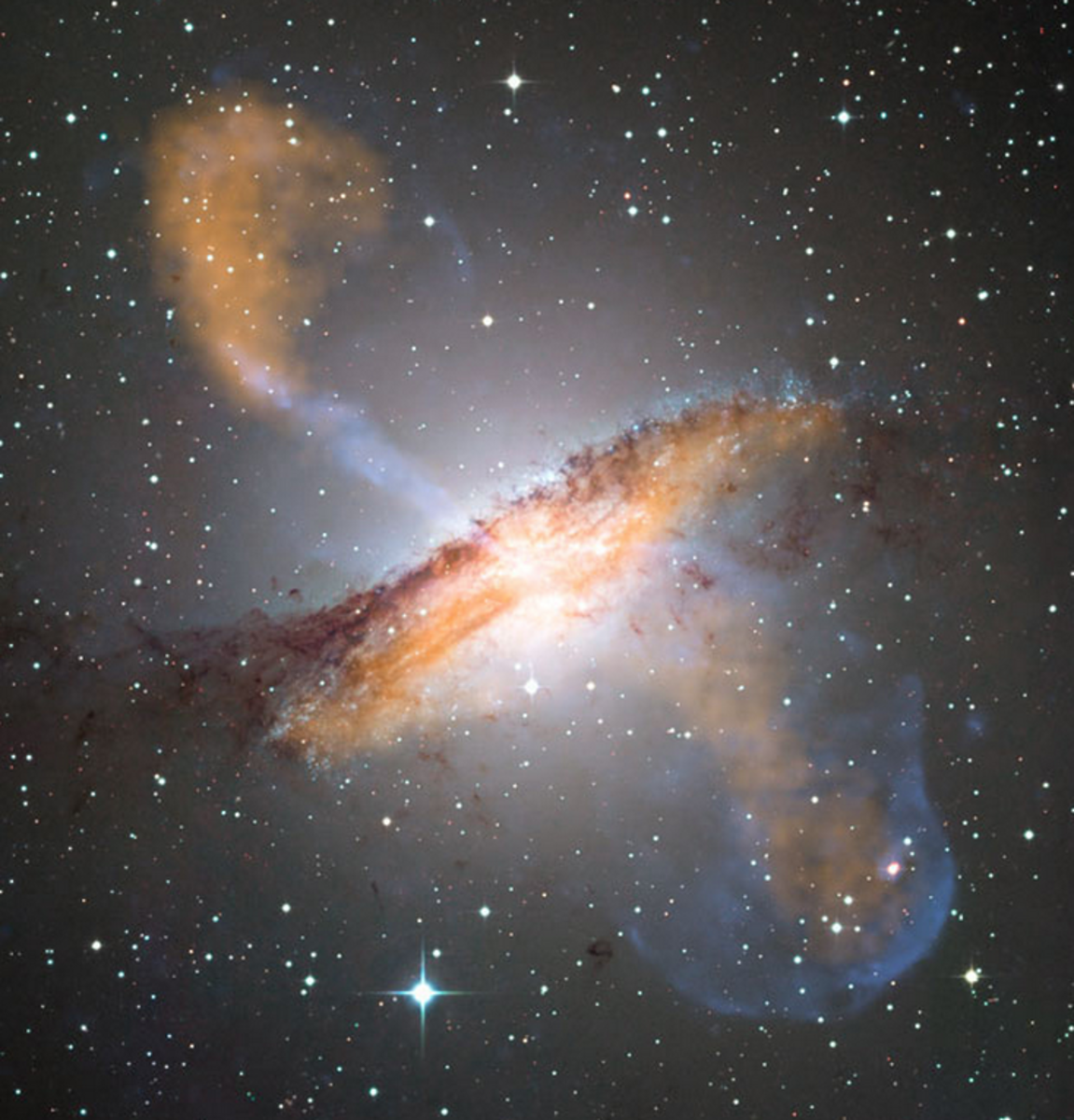 X ray wavelengths (blue) and microwaves (red) superimposed on a visible-light image of Galaxy NGC 5128 reveal the ghostly jets of a giant black hole the mass of 55 million suns.