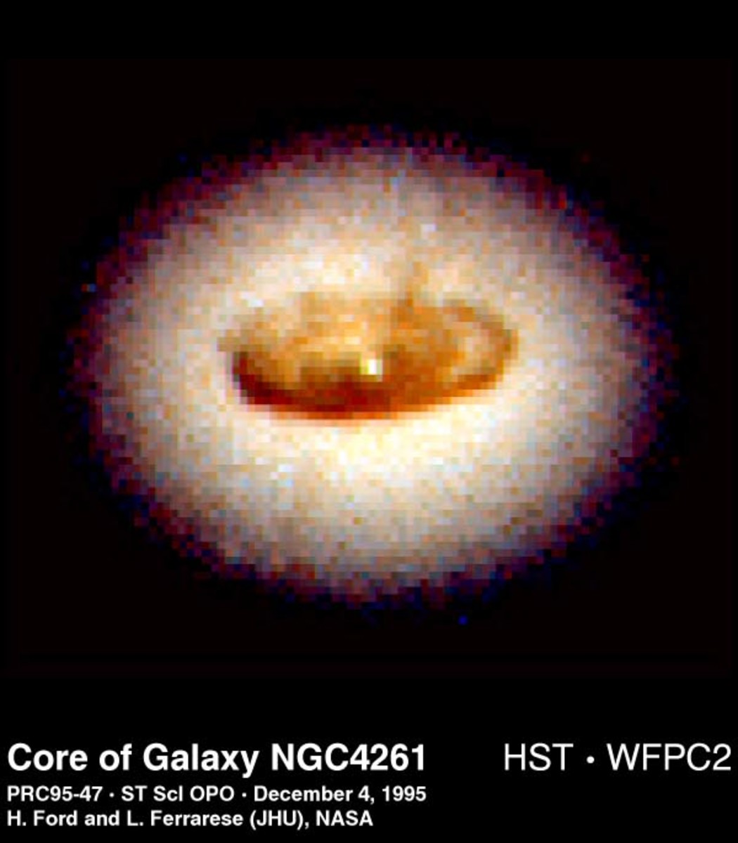 The Hubble Space Telescope images the swirling disk, stars, and gas around a supermassive black hole "1.2 billion times the mass of the Sun, yet concentrated into a region of space not much larger than our solar system." Core of Galaxy NGC 4261.