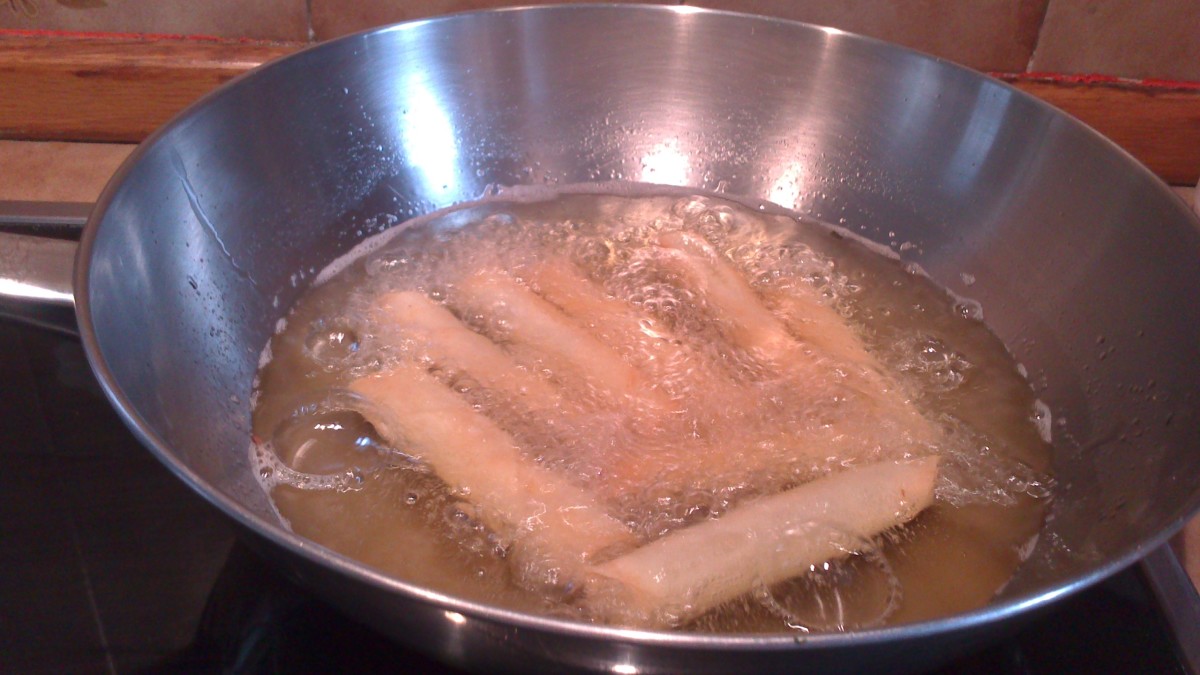 Frying the minced beef with carrots and potatoes spring rolls