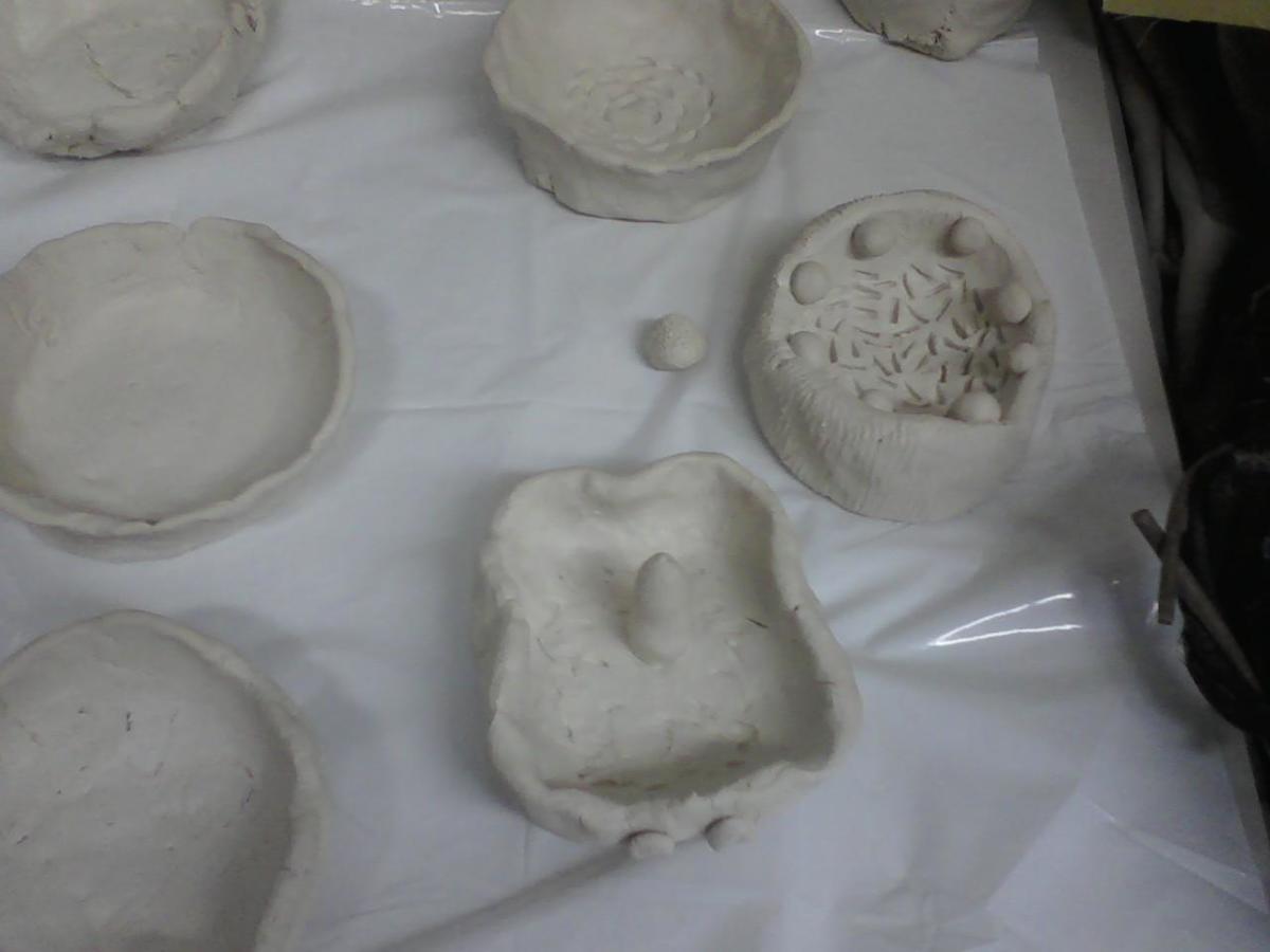 5th grade pinch pots, students used their fingertips dipped in water to smooth out some of the cracks