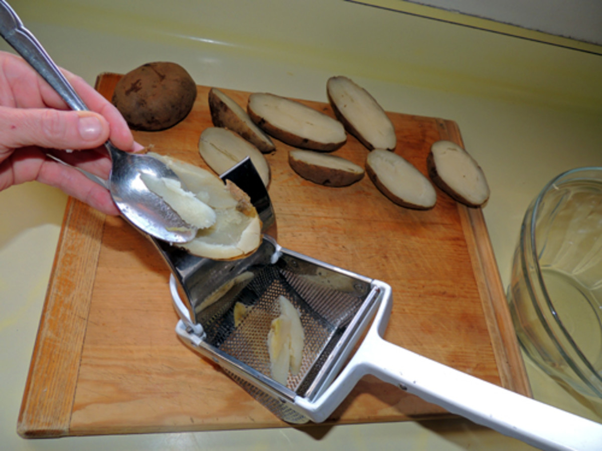 using hot baked potatoes, scoop meal into ricer like loading extremely large garlic press