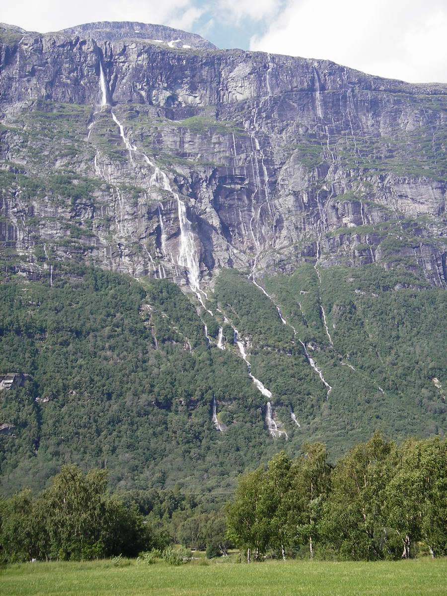 Vinnufossen Falls is located in Sunndal, Norway and cascades down a steep mountain side cliff face. Easily viewed in season from the roadside or up close Vinnufossen is a waterfall which can be visited by those wanting to see it.