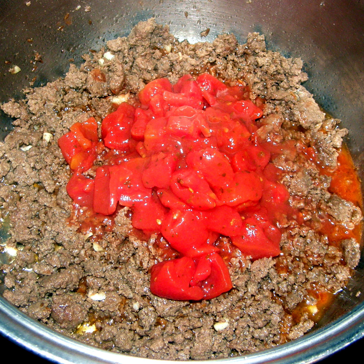 Add in the stewed tomatoes.