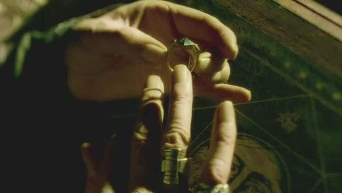 Dumbledore putting on the signet ring with the Stone.