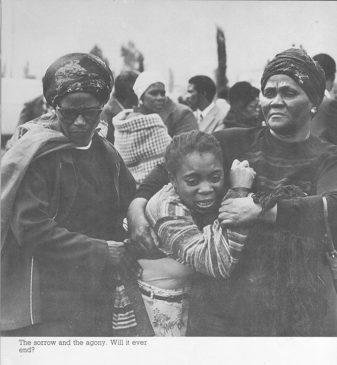 A woman crying from having lost a loved one. Africans spend most of their time, from the days of Apartheid murders and today's AIDS going to the cemetery to bury their dead, and crying most of the time.