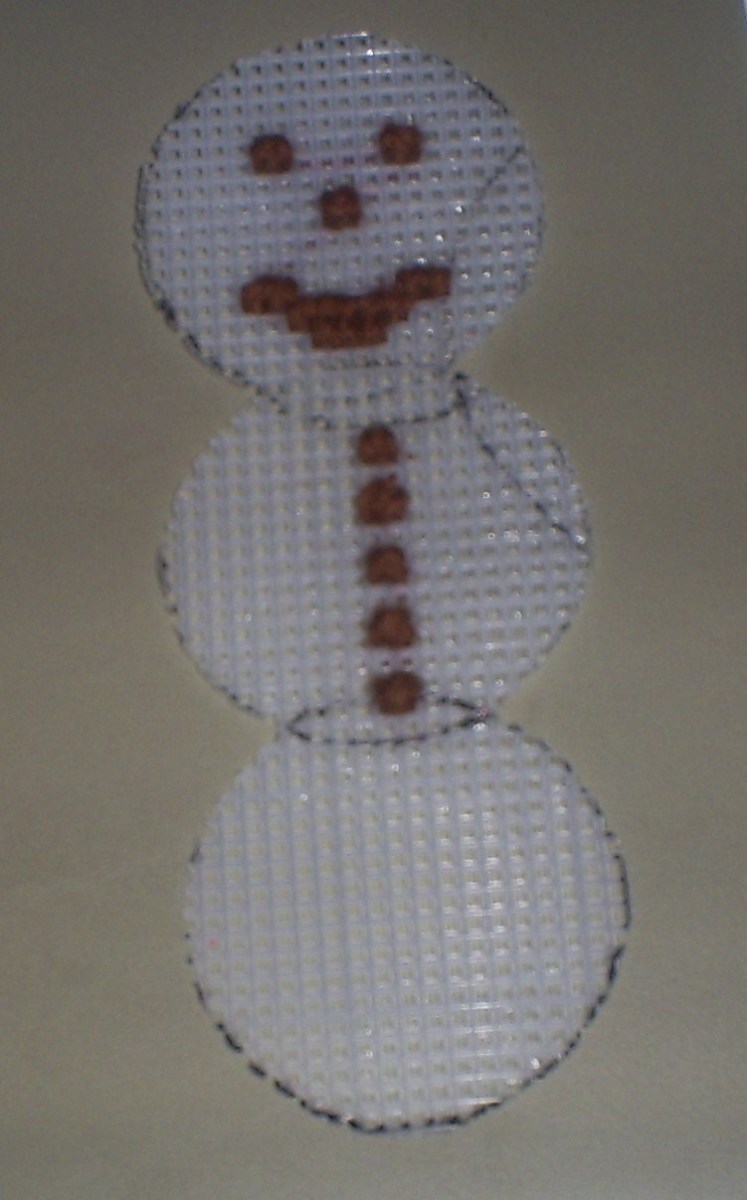Here I have sewn on the Snowman's buttons.