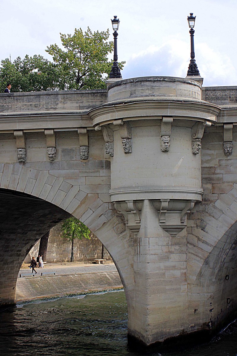 A view of Pont Neuf's ornamental detail from close up. The tourist boats allow buildings and bridges to be photographed from an angle not possible on dry land, and they make for a peaceful break from traipsing the streets