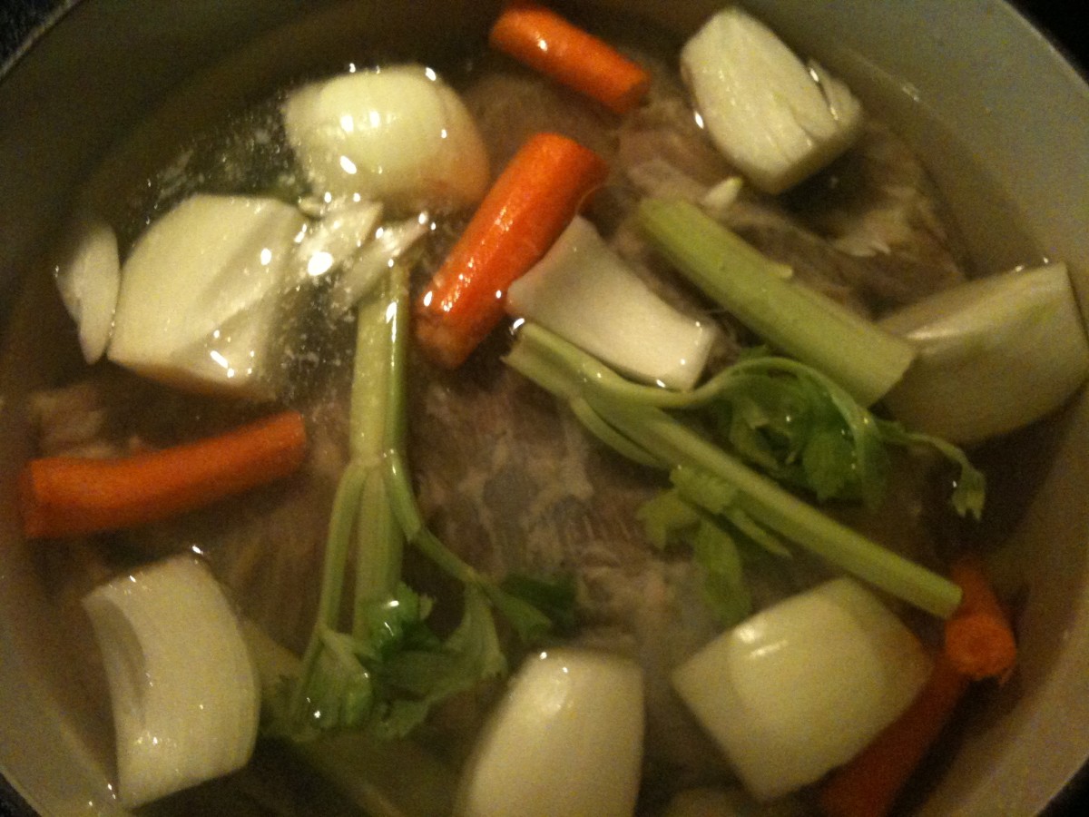 Brining done, the brisket hits the stockpot with some veggies to simmer.