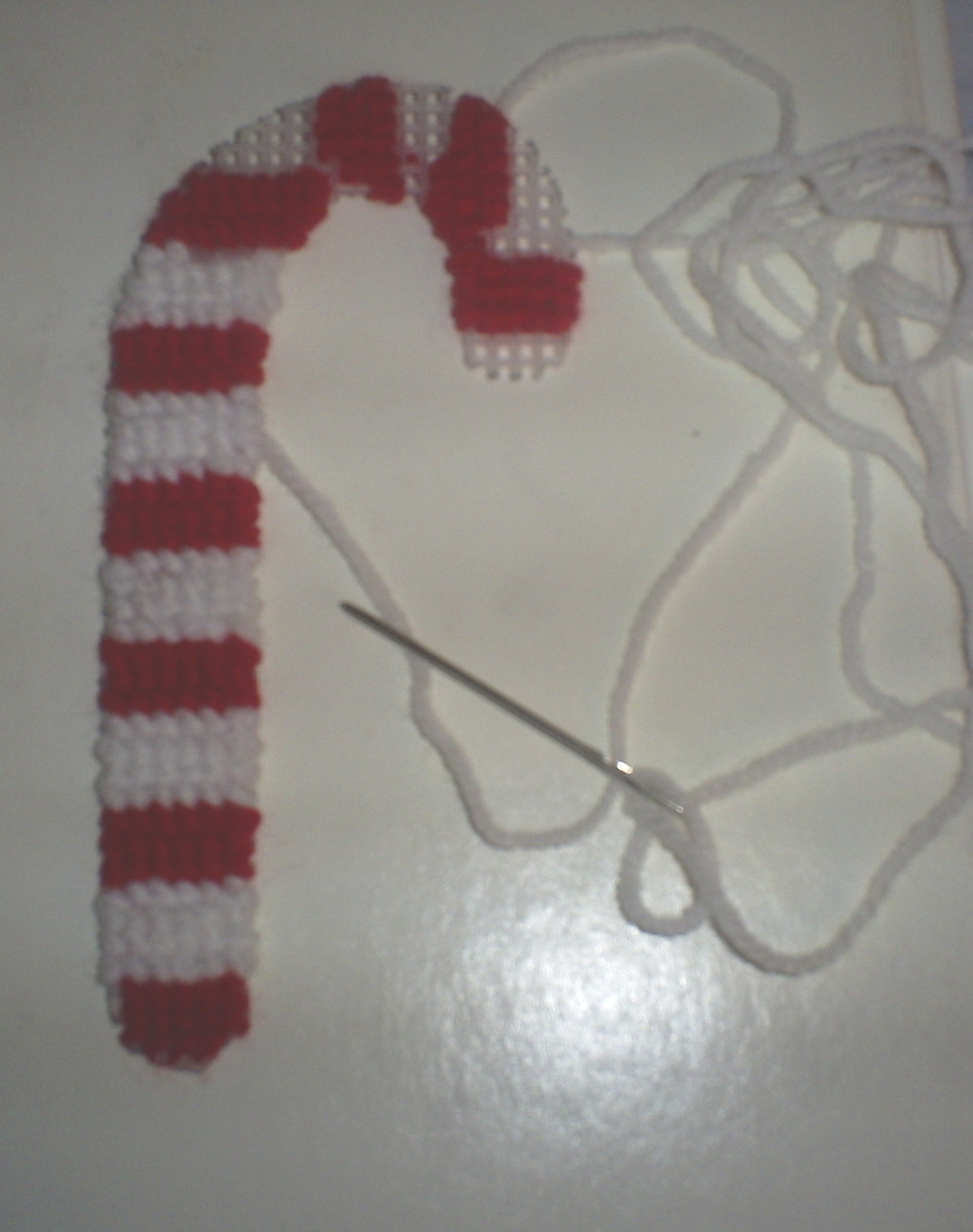This is what the candy cane looks like with almost all of the rows of white yarn added.