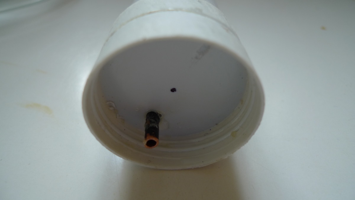 The cover of the extract container with the siphon peeping through. At the top you see how the air vent is constructed. I drilled a hole partially in the lid. It appears to be simple and very effective. 